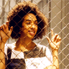 Bill smiling through a meshwire fence.